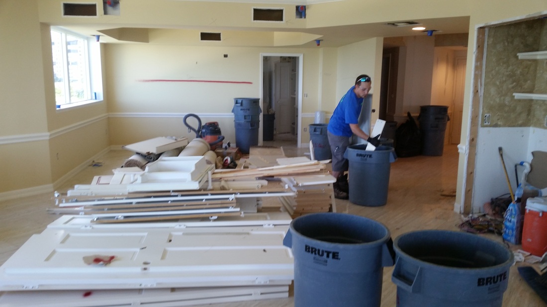 Eco Demolitions employees working on a commercial job site, organizing their debris into trash cans.