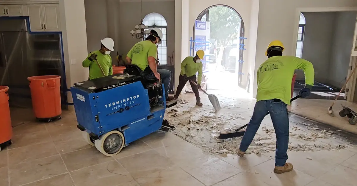 Employees of Eco Demolitions working together to remove and clean up the tile flooring in a nice Southwest Florida home.