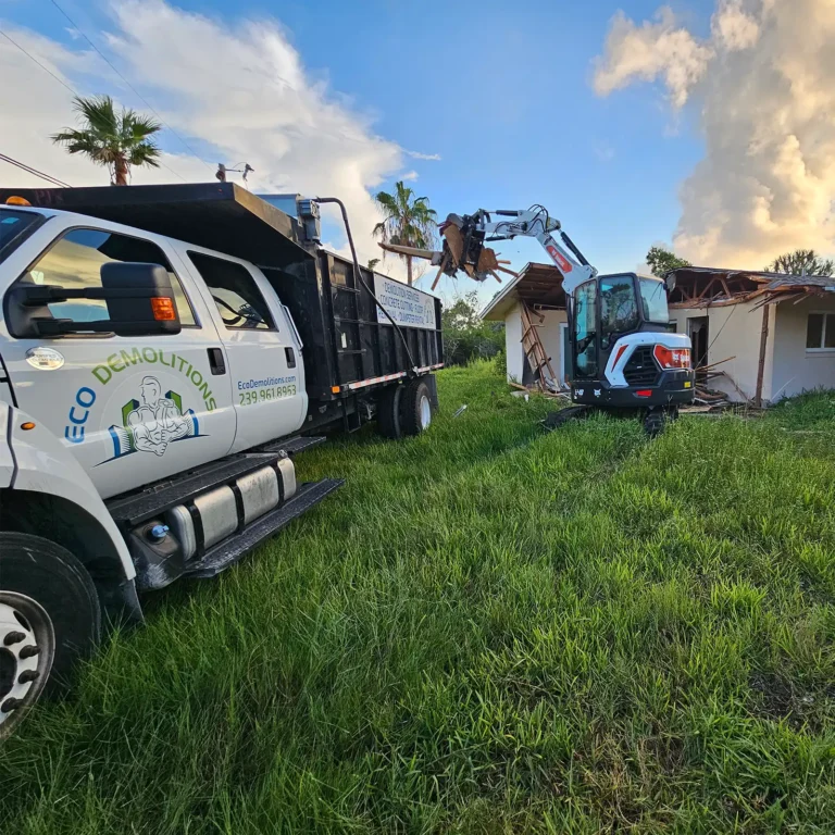 Emergency Dumpster Rentals: Quick Solutions for Unexpected Debris. Featuring an Eco Demolitions truck with dumpster on a job site to clear out debris from a damaged house.